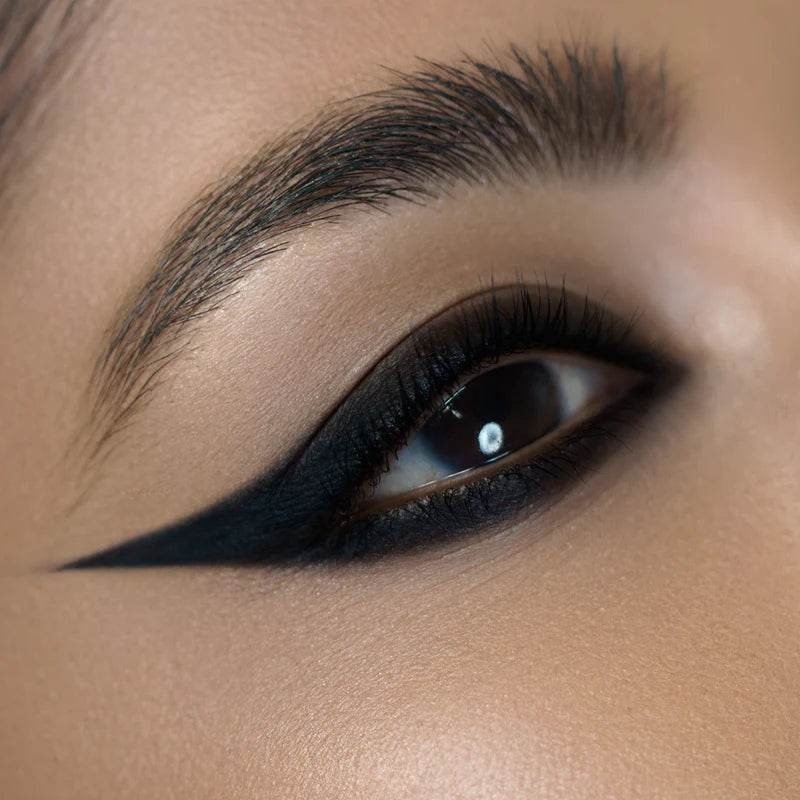 Draw the heavy black kohl line, top and bottom