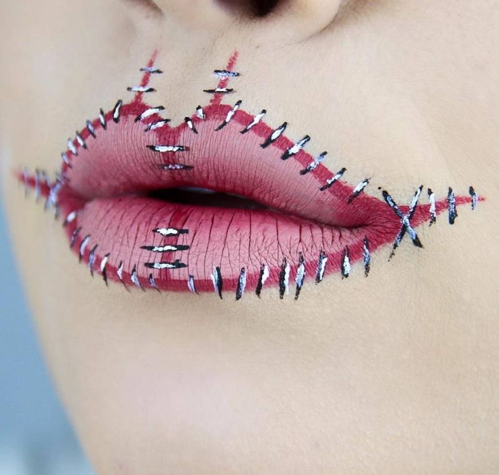 The stitched smile and ghost-blue lips
